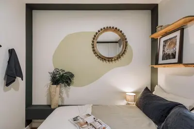 a bedroom with a bed and a mirror at Mescit - 2 bedrooms and balcony in Eixample Dreta in Barcelona
