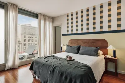 a living room with a couch and a table at Misir - 2 bedrooms and terrace in Eixample Dreta in Barcelona