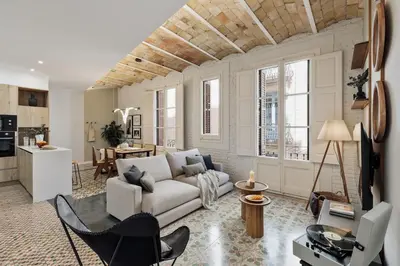 a dining room and living room with a table and chairs at Salar - 2 bedrooms in Gràcia in Barcelona