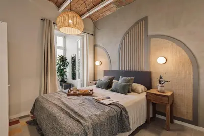 a bedroom with a bed and a potted plant at Pacaya - 2 bedrooms, office and balcony in Eixample Dreta in Barcelona