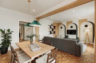 a dining room and living room with a table and chairs at Adile - 4 bedrooms and balcony in El Putxet in Barcelona