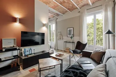 a bedroom with a white bed with two night stands and two lamps at Indiana - 2 bedrooms, office and balcony in Eixample Dreta in Barcelona