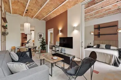a bathroom with a sink and a toilet and a mirror at Indiana - 2 bedrooms, office and balcony in Eixample Dreta in Barcelona