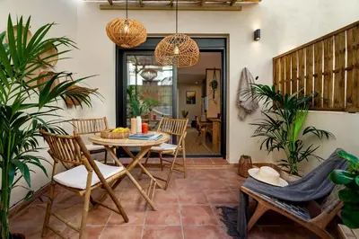 a patio with a table and chairs and plants at Batam - 1 bedroom and terrace in Gràcia in Barcelona