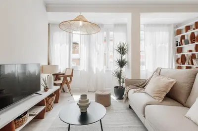 a white bedroom with a bed with a book on it at Stabia - 2 bedrooms in Sant Gervasi in Barcelona