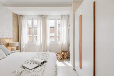 a kitchen with wooden cabinets and a tv on the wall at Stabia - 2 bedrooms in Sant Gervasi in Barcelona