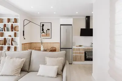 a living room with a couch and a kitchen at Stabia - 2 bedrooms in Sant Gervasi in Barcelona
