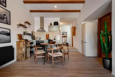 a living room with a red couch and a table at Hassi - 2 bedrooms and terrace in Gràcia in Barcelona