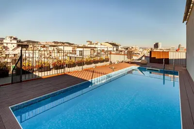 a swimming pool on the roof of a building at Sumbawa - 2 bedrooms in Eixample Dreta in Barcelona
