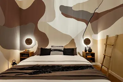 a bedroom with a bed with a wall mural at Sumbawa - 2 bedrooms in Eixample Dreta in Barcelona