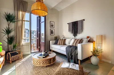 a bedroom with a bed with a blue comforter at Lidi - 2 bedrooms and balcony in Eixample Esquerra in Barcelona