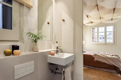 a living room with a white couch and a tv at Lidi - 2 bedrooms and balcony in Eixample Esquerra in Barcelona