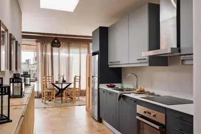 a large kitchen with a counter and a sink at Finnt - 1 bedroom and terrace in Eixample Dreta in Barcelona