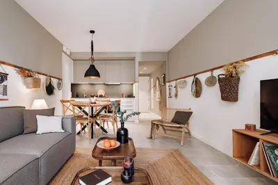 a dining room with a wooden table and chairs at Pinar - 2 bedrooms and office in Eixample Esquerra in Barcelona