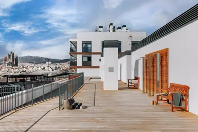 a bedroom with a large bed and a hallway at Idir - 2 bedrooms, a pool and terrace in Poblenou in Barcelona
