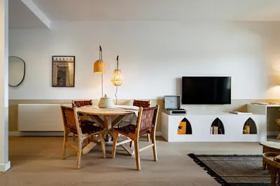 a living room with a table and a living room with a couch at Idir - 2 bedrooms, a pool and terrace in Poblenou in Barcelona