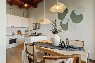 a kitchen with a table with a vase on it at Chixoy - 3 bedrooms and balcony in Eixample Dreta in Barcelona