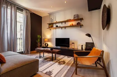 a living room with a couch and a desk at Hegra - 2 bedrooms, balcony in Eixample Esquerra in Barcelona