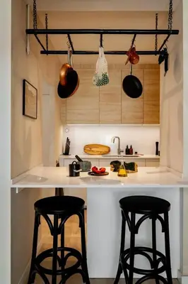 a kitchen with white cabinets and a black counter top at Rissani - 2 bedrooms in Sant Gervasi in Barcelona
