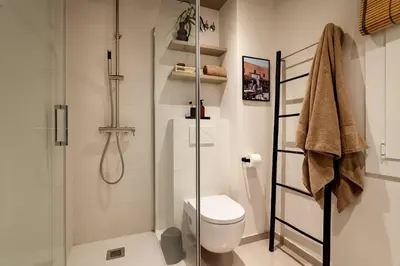 a room with a shelf and a table and a mirror at Rissani - 2 bedrooms in Sant Gervasi in Barcelona