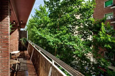 a room with a mirror and a stool and a plant at Rissani - 2 bedrooms in Sant Gervasi in Barcelona