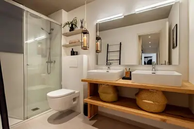 a bathroom with a toilet and a glass door at Rissani - 2 bedrooms in Sant Gervasi in Barcelona