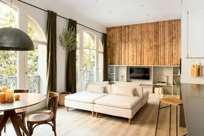 a living room with a white couch and a table at Ebro - 3 bedrooms in Gràcia in Barcelona