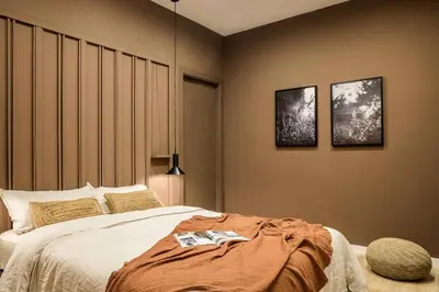 a bed with a green headboard and two pillows at Ebro - 3 bedrooms in Gràcia in Barcelona
