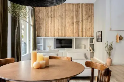 a living room with a couch and two windows at Ebro - 3 bedrooms in Gràcia in Barcelona