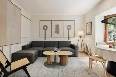 a living room with a table and a tv at Izabal - 3 bedrooms and office in Eixample Esquerra in Barcelona