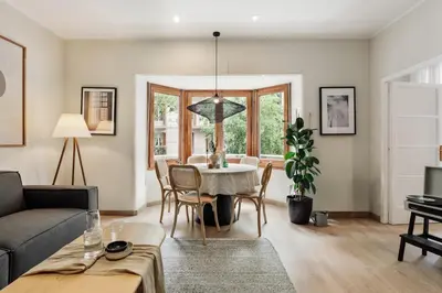 a dining room with a table and chairs and a potted plant at Izabal - 3 bedrooms and office in Eixample Esquerra in Barcelona