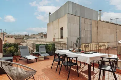 a patio with a table and chairs on a roof at Marmara - 3 bedrooms and terrace in Sant Pere in Barcelona