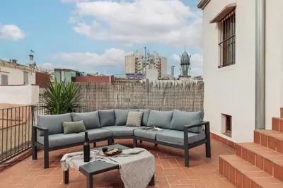 a patio with a couch and a table on a balcony at Marmara - 3 bedrooms and terrace in Sant Pere in Barcelona