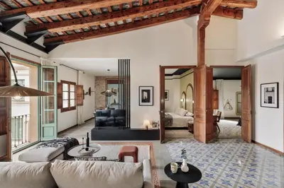 a bedroom with a bed and a chair and a window at Marmara - 3 bedrooms and terrace in Sant Pere in Barcelona