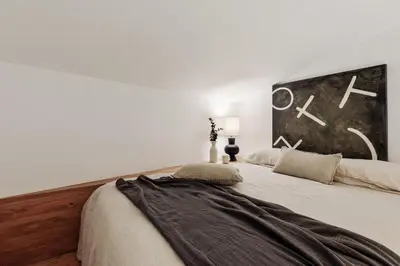 a bedroom with a bed with a mirror and a chair at Mille - 2 bedrooms and terrace in Poblenou in Barcelona