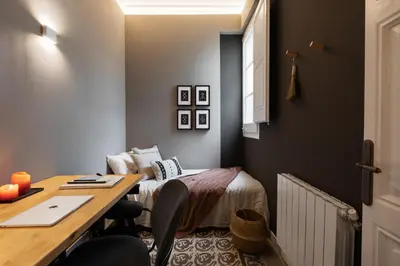 a bedroom with a desk and a bed with a mirror at Erfoud - 3 bedrooms in Gràcia in Barcelona