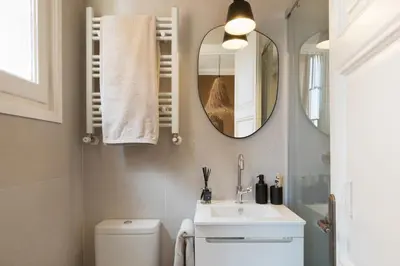 a hallway with a chair and a table at Erfoud - 3 bedrooms in Gràcia in Barcelona