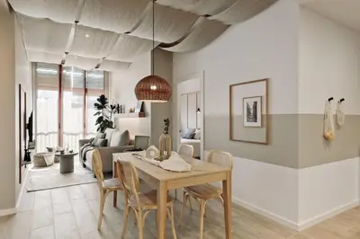 a dining room with a table and chairs and a living room at Canadell - 2 bedrooms in Sant Antoni in Barcelona