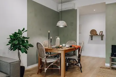 a living room with a flat screen tv on a wall at Alhamilla - 1 bedroom in Eixample Dreta in Barcelona