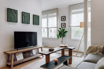 a dining room table with chairs and a pendant light at Alhamilla - 1 bedroom in Eixample Dreta in Barcelona