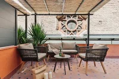 a patio with chairs and a table and a window at Ixchel - 3 bedrooms, terrace and balcony in Gràcia in Barcelona