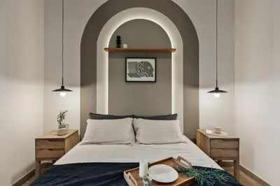 a bedroom with a bed and a chair and a mirror at Walla - 3 bedrooms and balcony in Eixample Dreta in Barcelona