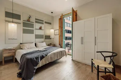 a bedroom with a bed and a table and a chair at Walla - 3 bedrooms and balcony in Eixample Dreta in Barcelona