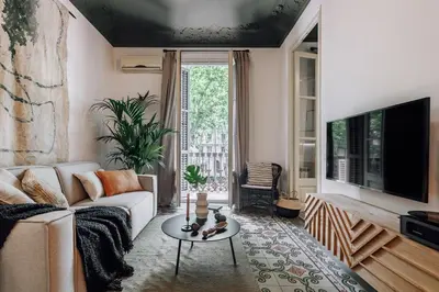a bedroom with a large bed and a large window at Hunde - 2 bedrooms in Eixample Esquerra in Barcelona