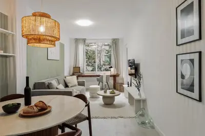 a living room with a table and a mirror at Drago - 3 bedrooms and balcony in Les Corts in Barcelona