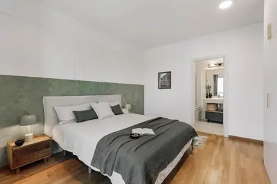 a bedroom with a bed and a desk with a chair at Gragnano - 2 bedrooms in Poblenou in Barcelona