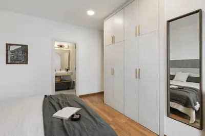 a bedroom with a bed and a desk with a laptop at Gragnano - 2 bedrooms in Poblenou in Barcelona