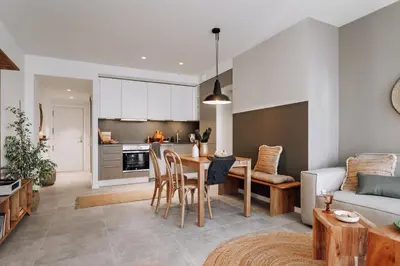 a kitchen with a table with a laptop on it at Zubia - 2 bedrooms in Eixample Esquerra in Barcelona