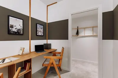 a home office with a desk and a laptop computer at Zubia - 2 bedrooms in Eixample Esquerra in Barcelona
