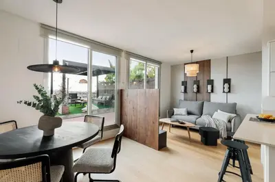 a bedroom with a large bed and a large window at Tossa - 2 bedroom and terrace in Eixample Esquerra in Barcelona